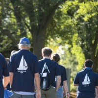 GVSU alumni walk in a pack from GVSU Alumni House and Visitor Center to dorm buildings